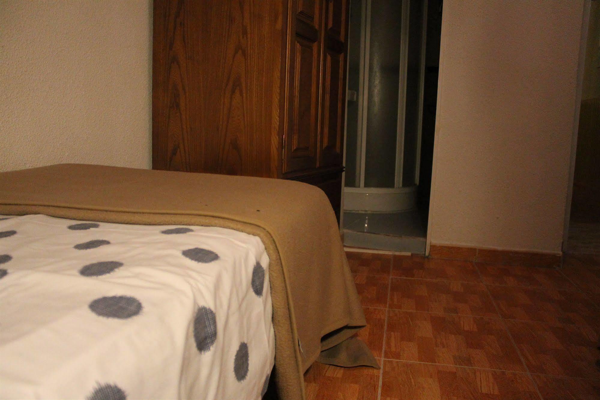 Hostal Los Perales Madrid Esterno foto A bed with a sábanas
